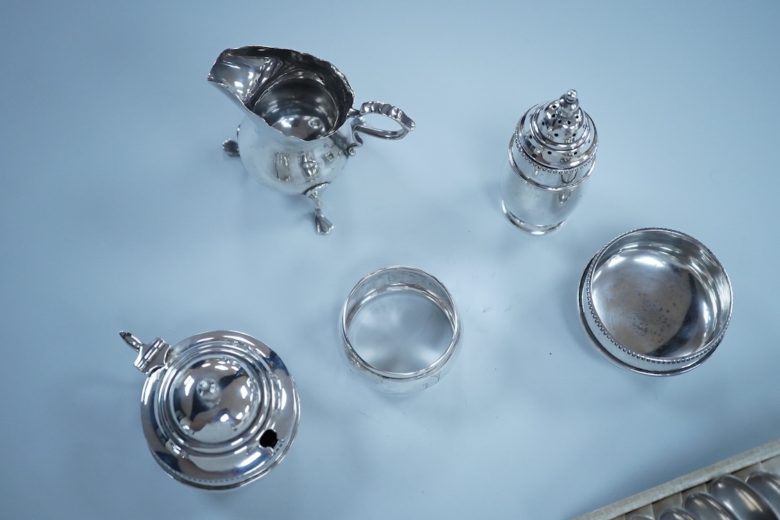 Small silver including a three piece cruet set, by George Howson, Sheffield, 1924/5/6, a napkin ring, a cream jug and a set of six 830s coffee spoons.
